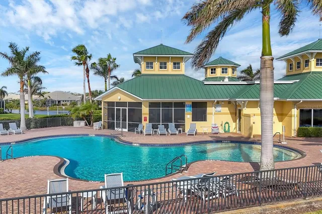 a view of a white house with a big yard and plants