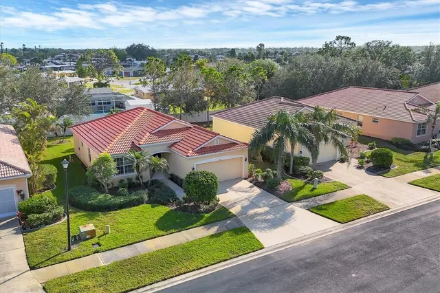 an aerial view of multiple houses with a yard