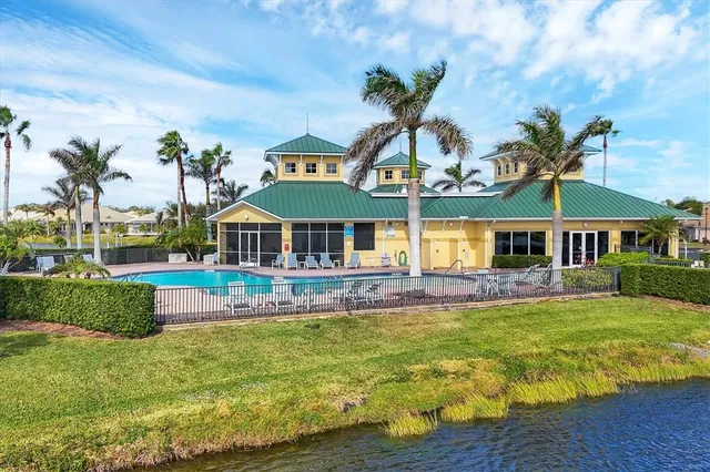 a front view of house with a garden and swimming pool