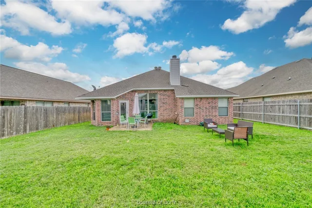 a view of a house with a yard porch and sitting area