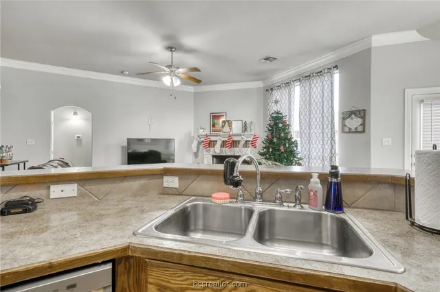 a kitchen with a sink and a refrigerator