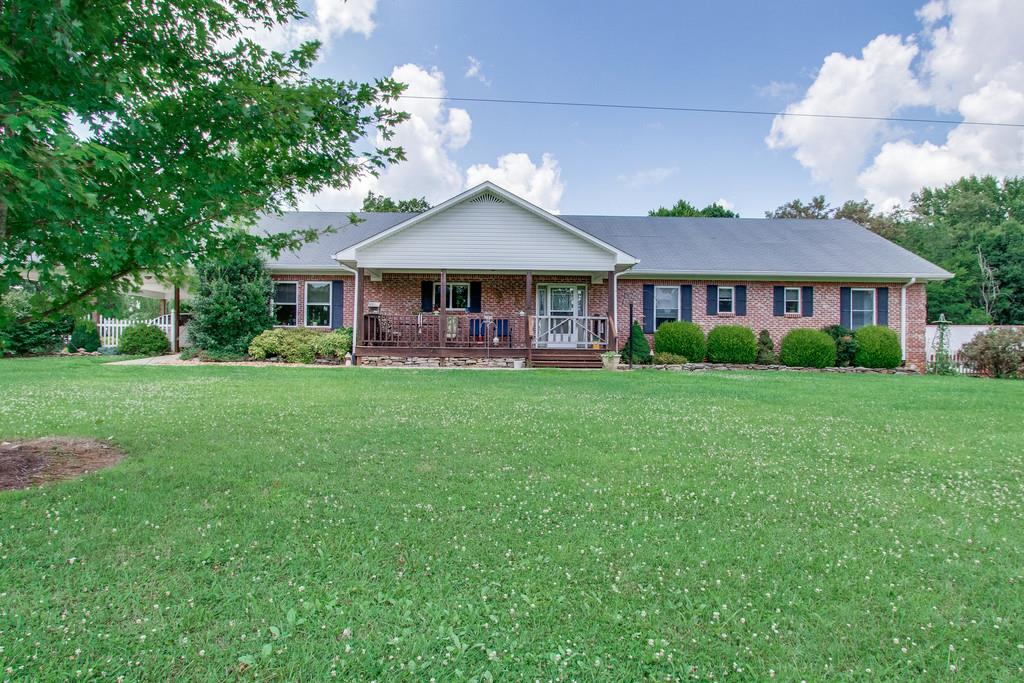 596 Goad Ridge Lane Pleasant Shade, TN 37145 - Photo 2 of 30 a front view of a house with a garden and trees