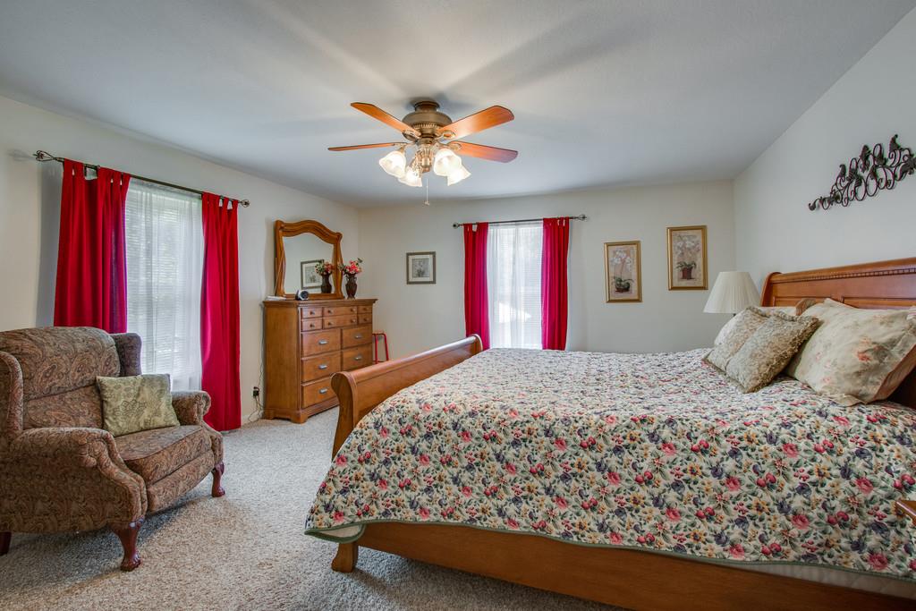 596 Goad Ridge Lane Pleasant Shade, TN 37145 - Photo 13 of 30 a bedroom with a bed and a chandelier