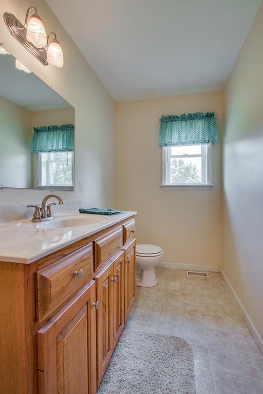 596 Goad Ridge Lane Pleasant Shade, TN 37145 - Photo 18 of 30 a bathroom with a toilet sink and mirror