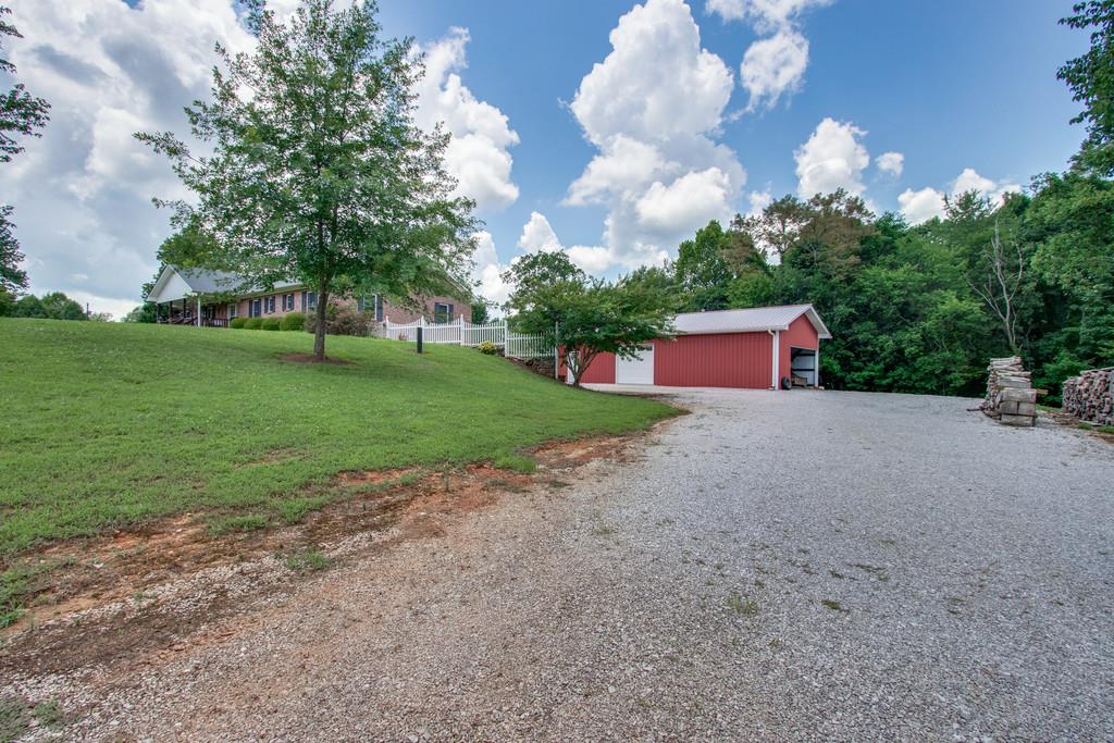596 Goad Ridge Lane Pleasant Shade, TN 37145 - Photo 29 of 30 a front view of a house with garden