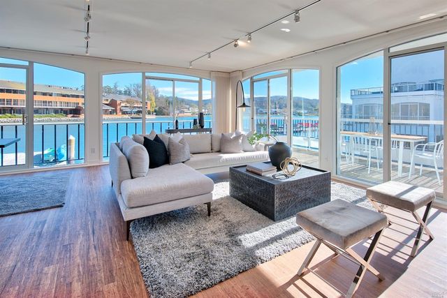 a living room with furniture and large windows