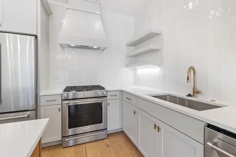a kitchen with a stove top oven and sink