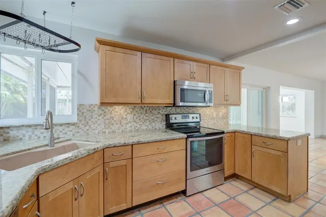 a kitchen with a sink stove and cabinets