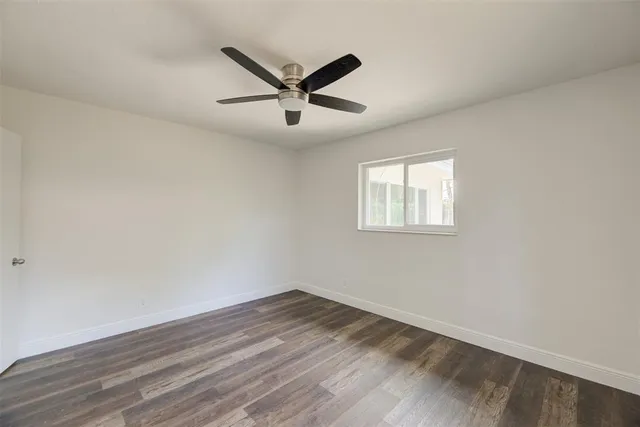 a view of a big room with wooden floor closet and windows