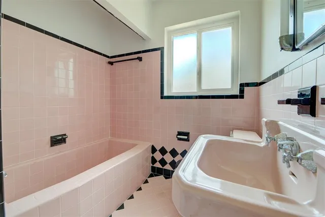 a bathroom with a sink a bathtub and a shower