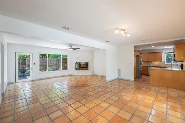 a view of a kitchen with furniture and a refrigerator