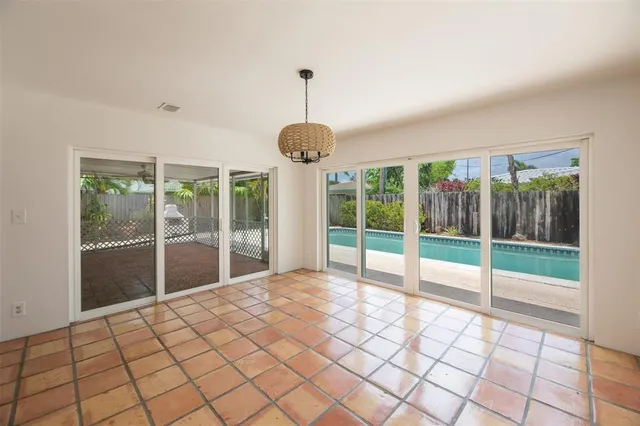 a view of an empty room and window ceiling fan