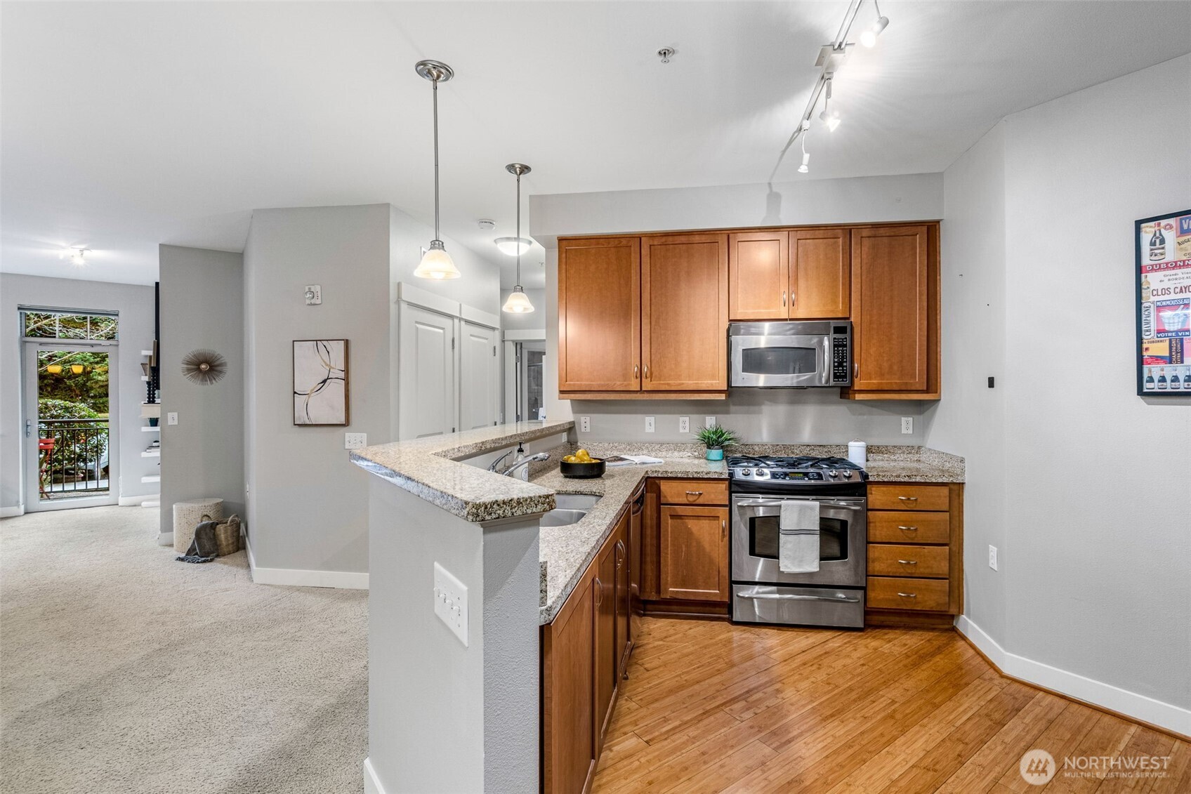 15700 116th Avenue Northeast, Unit 102A Bothell, WA 98011 - Photo 10 of 35 a kitchen with stainless steel appliances granite countertop a stove and a refrigerator