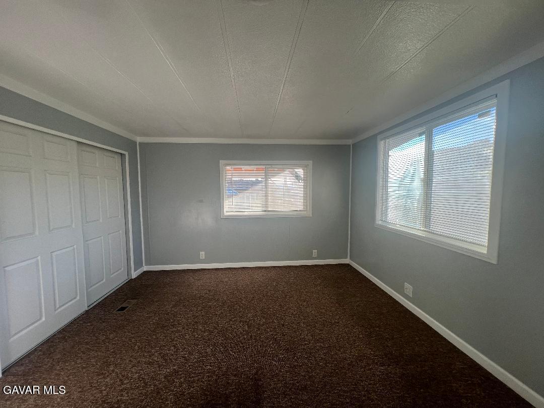 3300 15th Street West, Unit SPC 57 Rosamond, CA 93560 - Photo 13 of 23 an empty room with windows