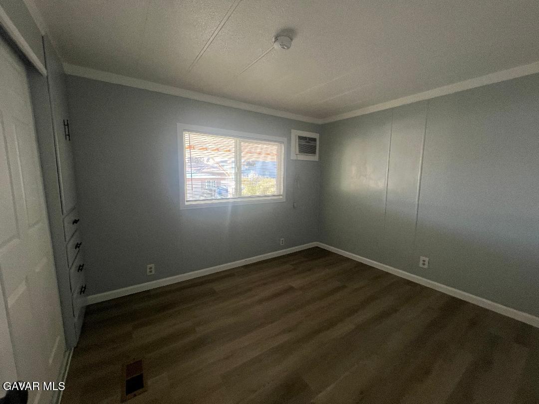 3300 15th Street West, Unit SPC 57 Rosamond, CA 93560 - Photo 16 of 23 an empty room with wooden floor and windows