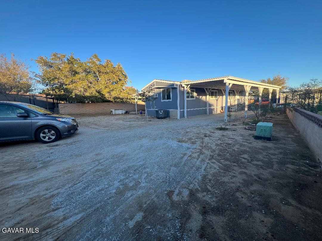 3300 15th Street West, Unit SPC 57 Rosamond, CA 93560 - Photo 22 of 23 a front view of a house with a garden