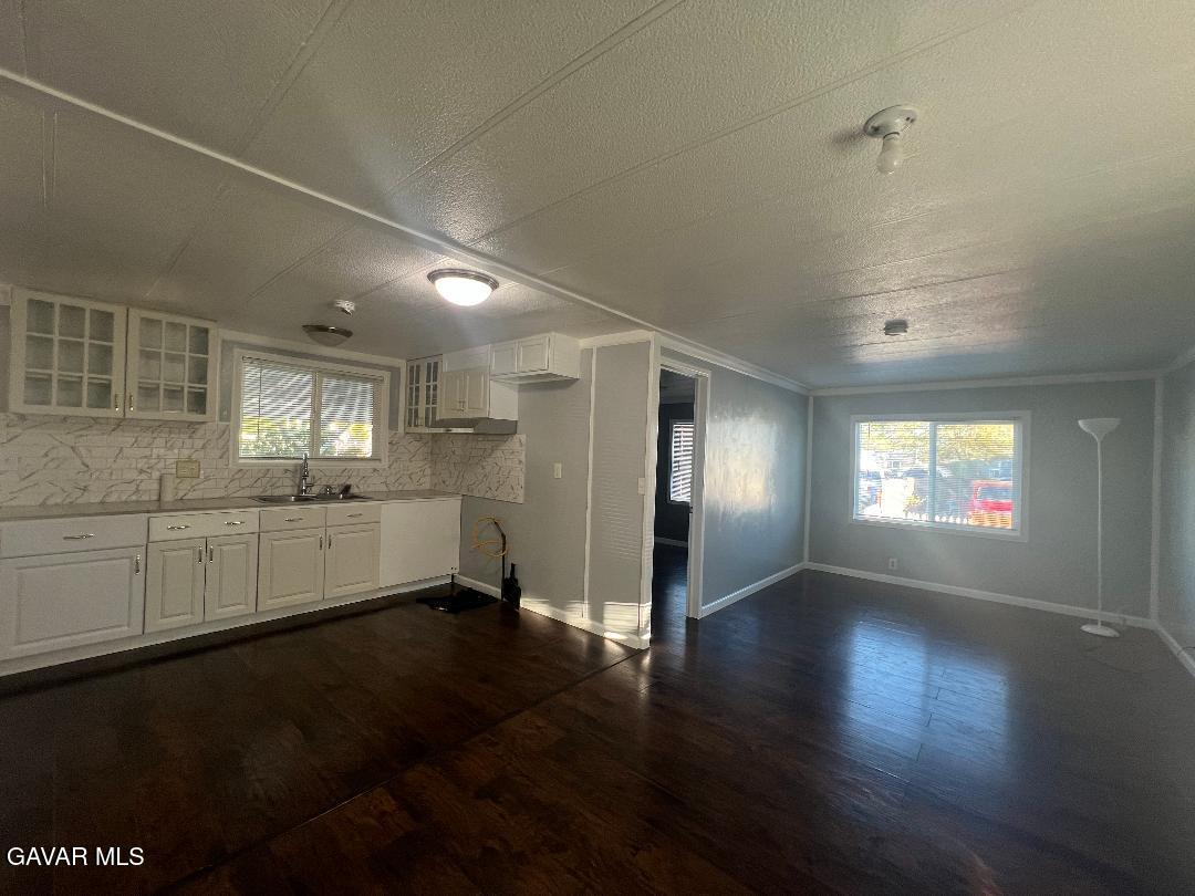 3300 15th Street West, Unit SPC 57 Rosamond, CA 93560 - Photo 6 of 23 an empty room with wooden floor and windows
