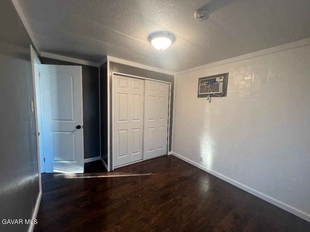 3300 15th Street West, Unit SPC 57 Rosamond, CA 93560 - Photo 9 of 23 an empty room with wooden floor and windows