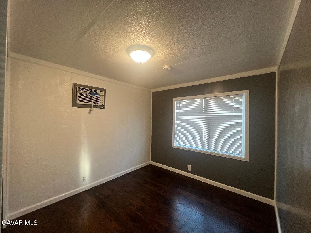 3300 15th Street West, Unit SPC 57 Rosamond, CA 93560 - Photo 10 of 23 an empty room with wooden floor and windows