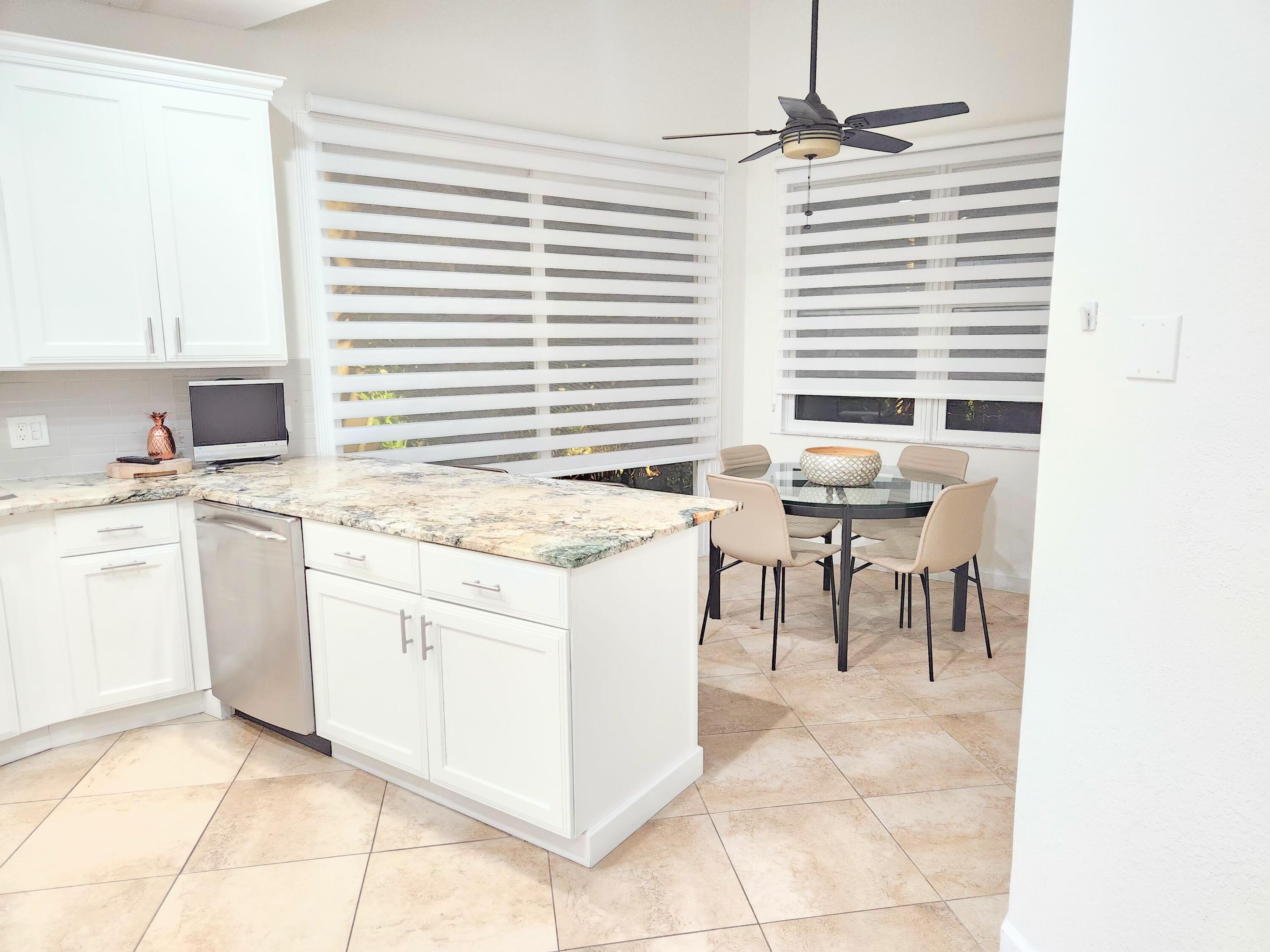 3567 Commodore Circle Delray Beach, FL 33483 - Photo 19 of 76 a kitchen with a sink cabinets and window