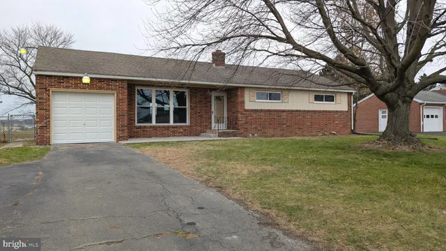 a front view of house with yard and trees
