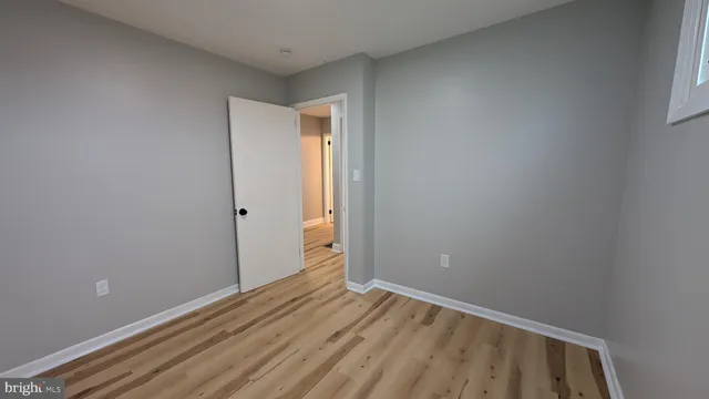 a view of room with wooden floor