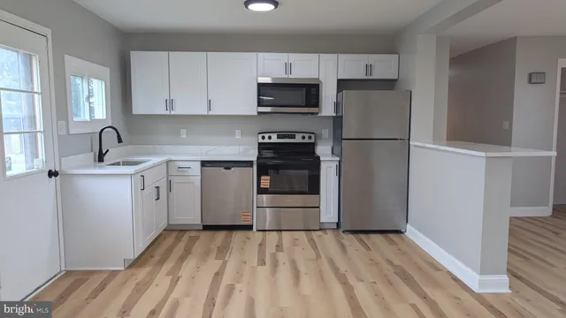 a kitchen with a sink a stove and refrigerator