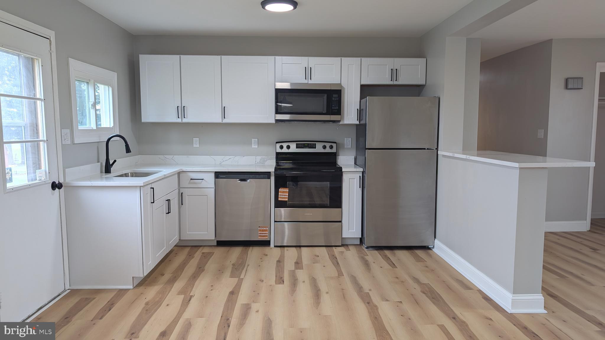70 Hellers Church Road Leola, PA 17540 - Photo 7 of 25 a kitchen with a sink a stove and refrigerator