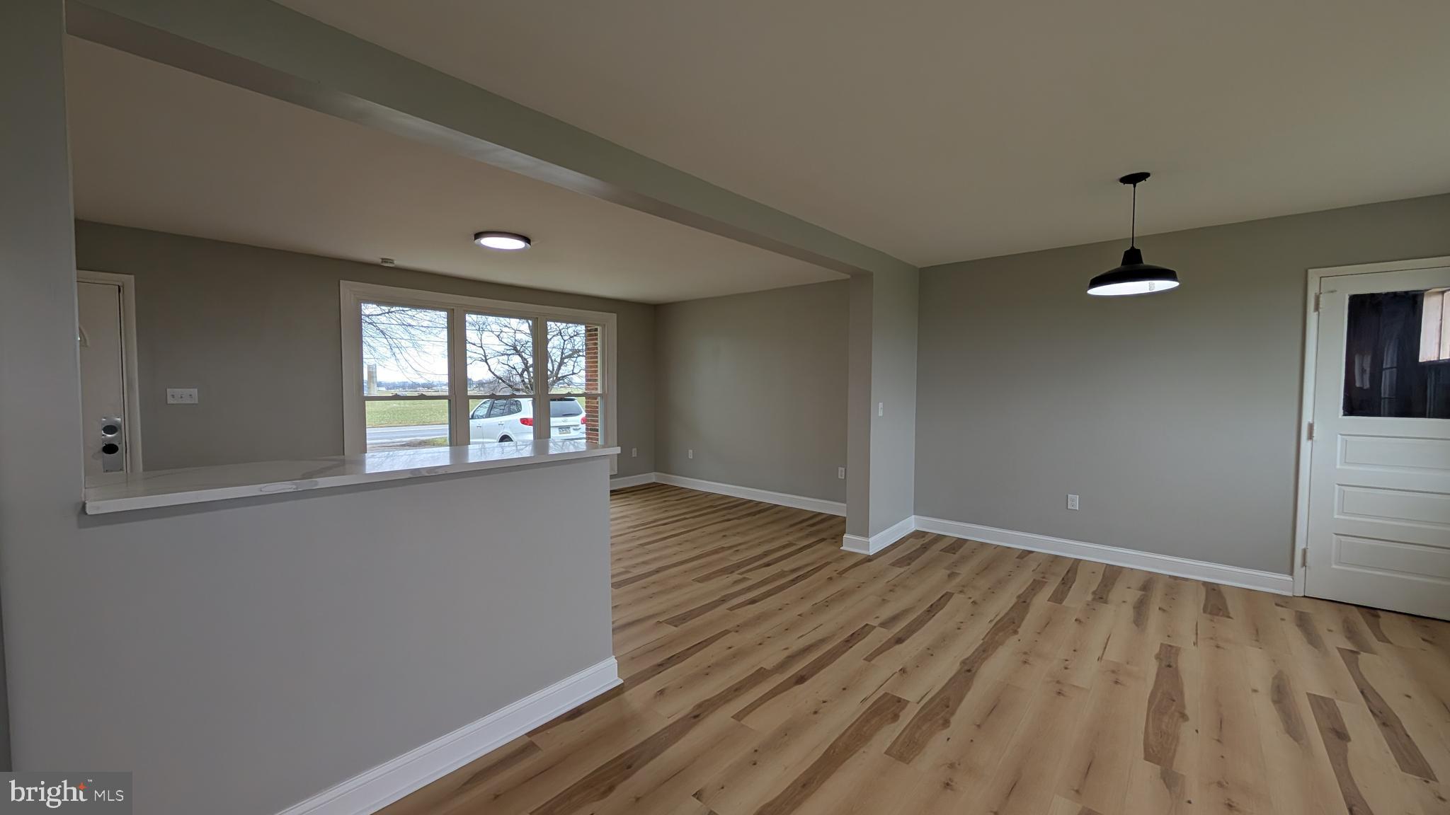 70 Hellers Church Road Leola, PA 17540 - Photo 9 of 25 an empty room with wooden floor and windows