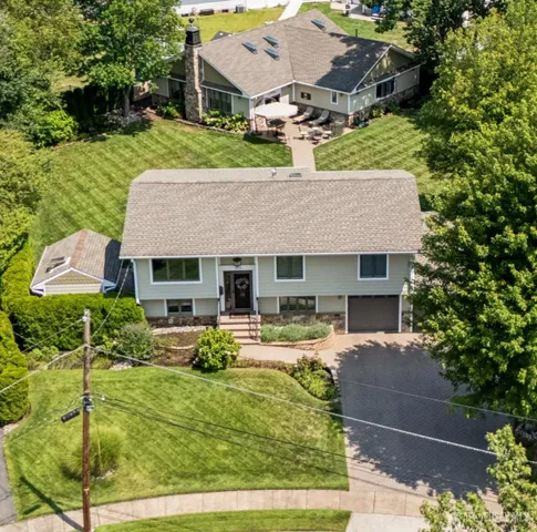 a aerial view of a house with swimming pool garden and patio