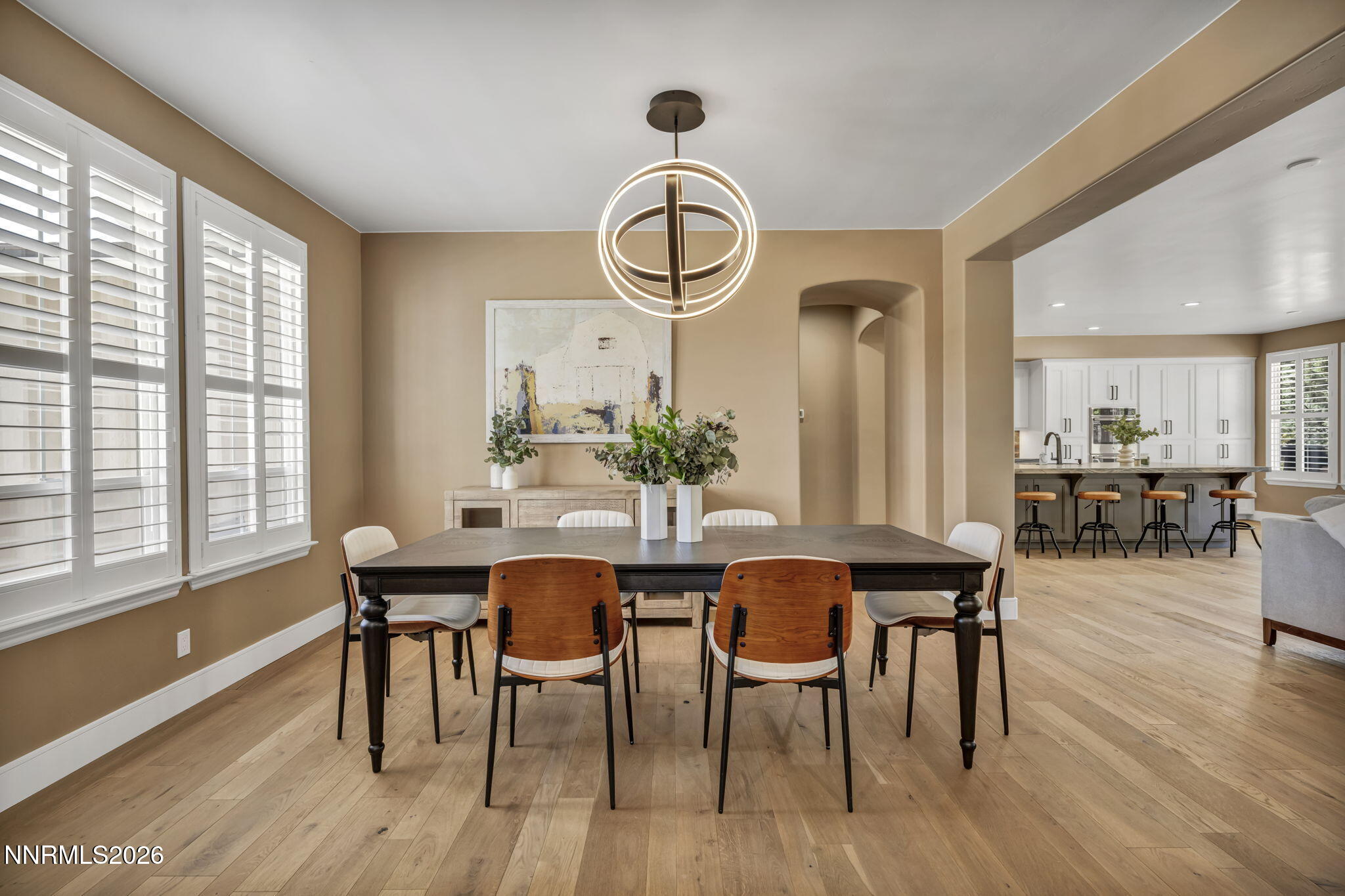 2965 Roundrock Court Reno, NV 89511 - Photo 3 of 40 a dining room with wooden floor a chandelier a wooden table and chairs