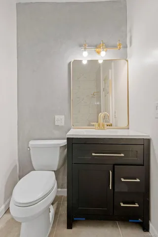 a bathroom with a sink a toilet and mirror