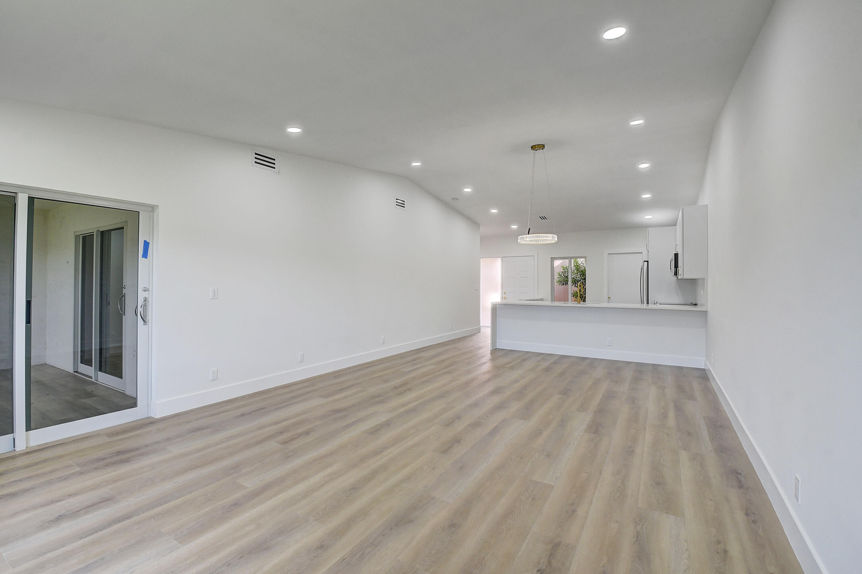 8204 Summerbreeze Lane Boca Raton, FL 33496 - Photo 11 of 47 an empty room with wooden floor and windows