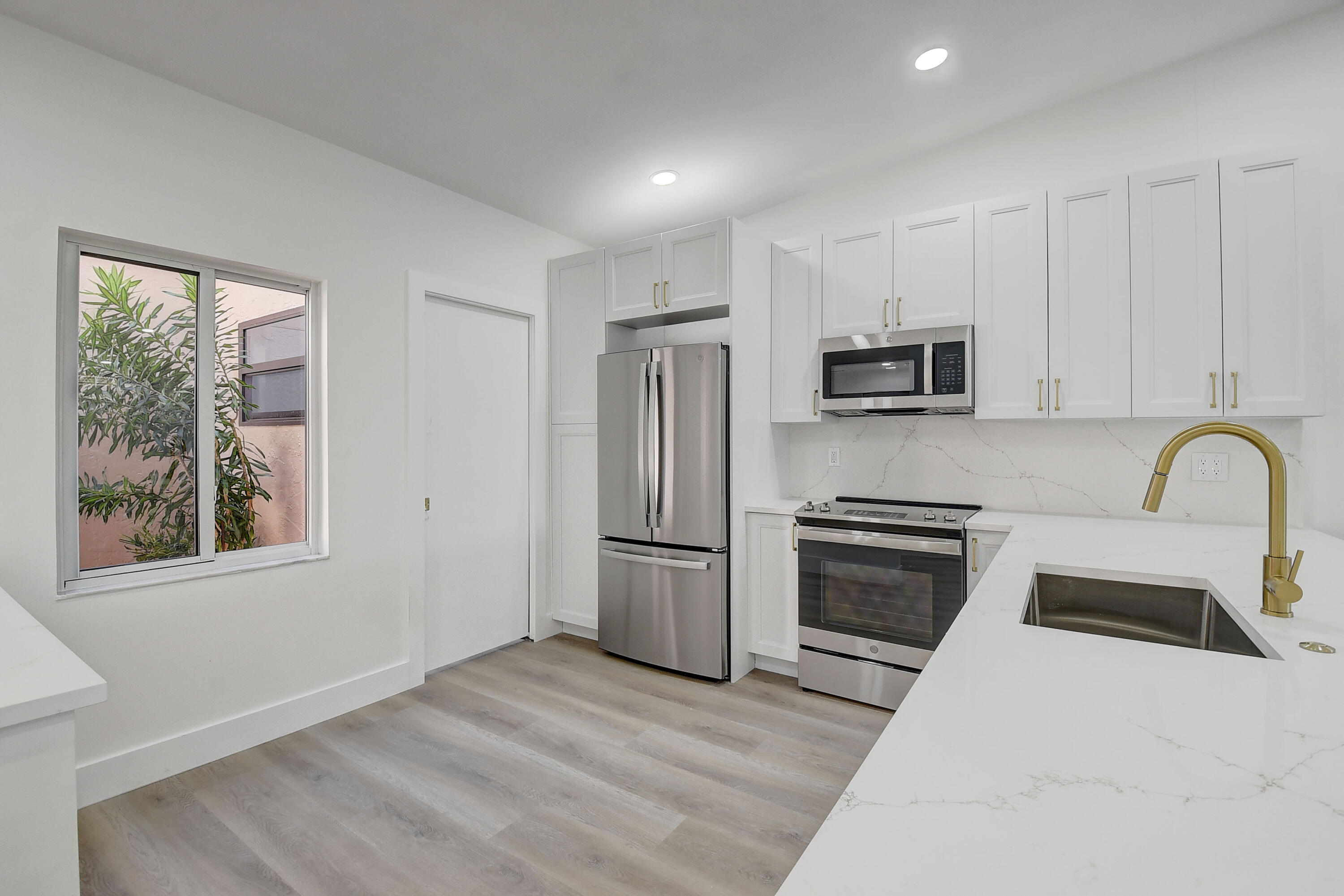 8204 Summerbreeze Lane Boca Raton, FL 33496 - Photo 13 of 47 a kitchen with a refrigerator stove and sink