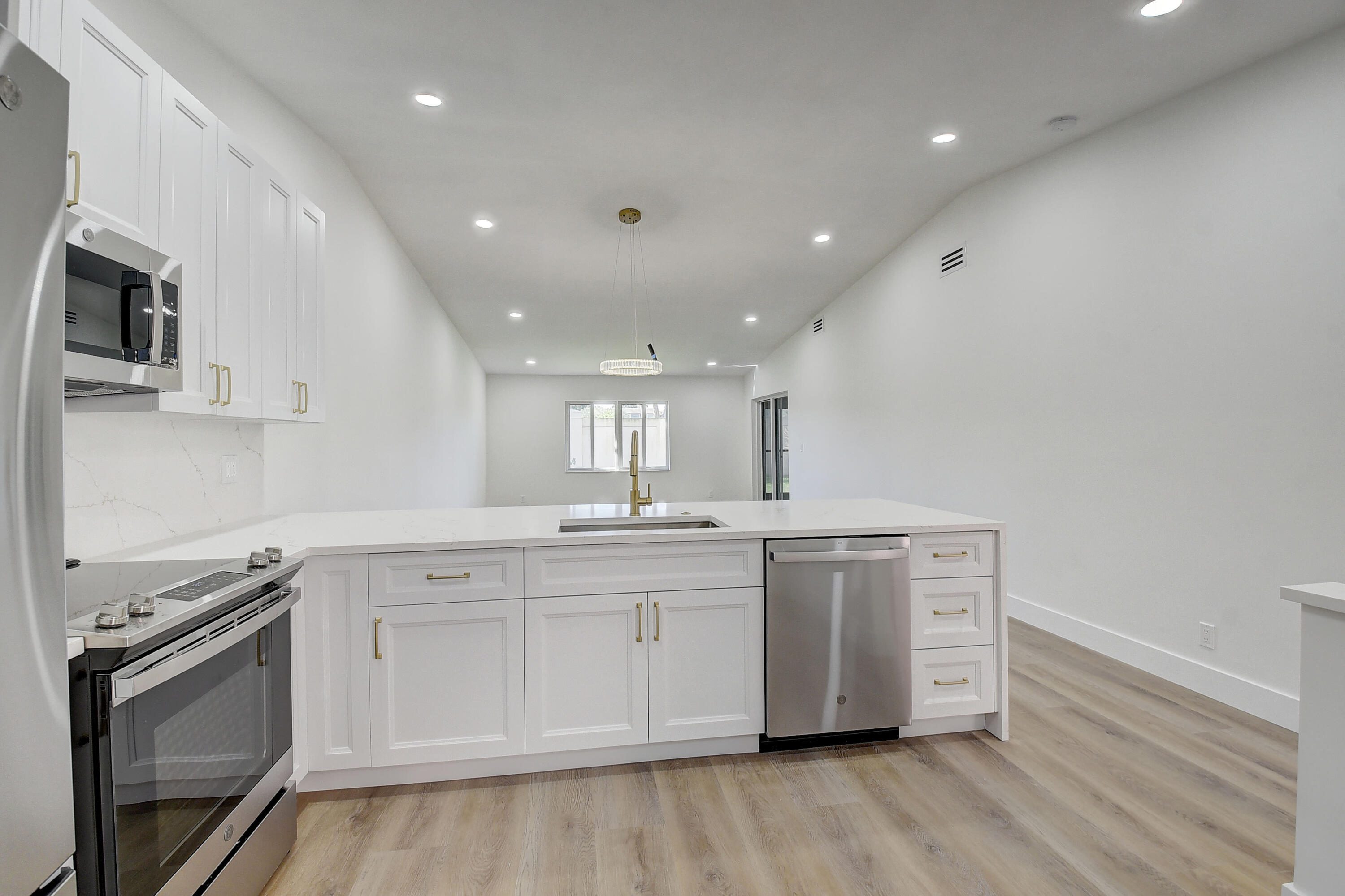 8204 Summerbreeze Lane Boca Raton, FL 33496 - Photo 15 of 47 a view of a kitchen with electric stainless steel appliances and wooden floor