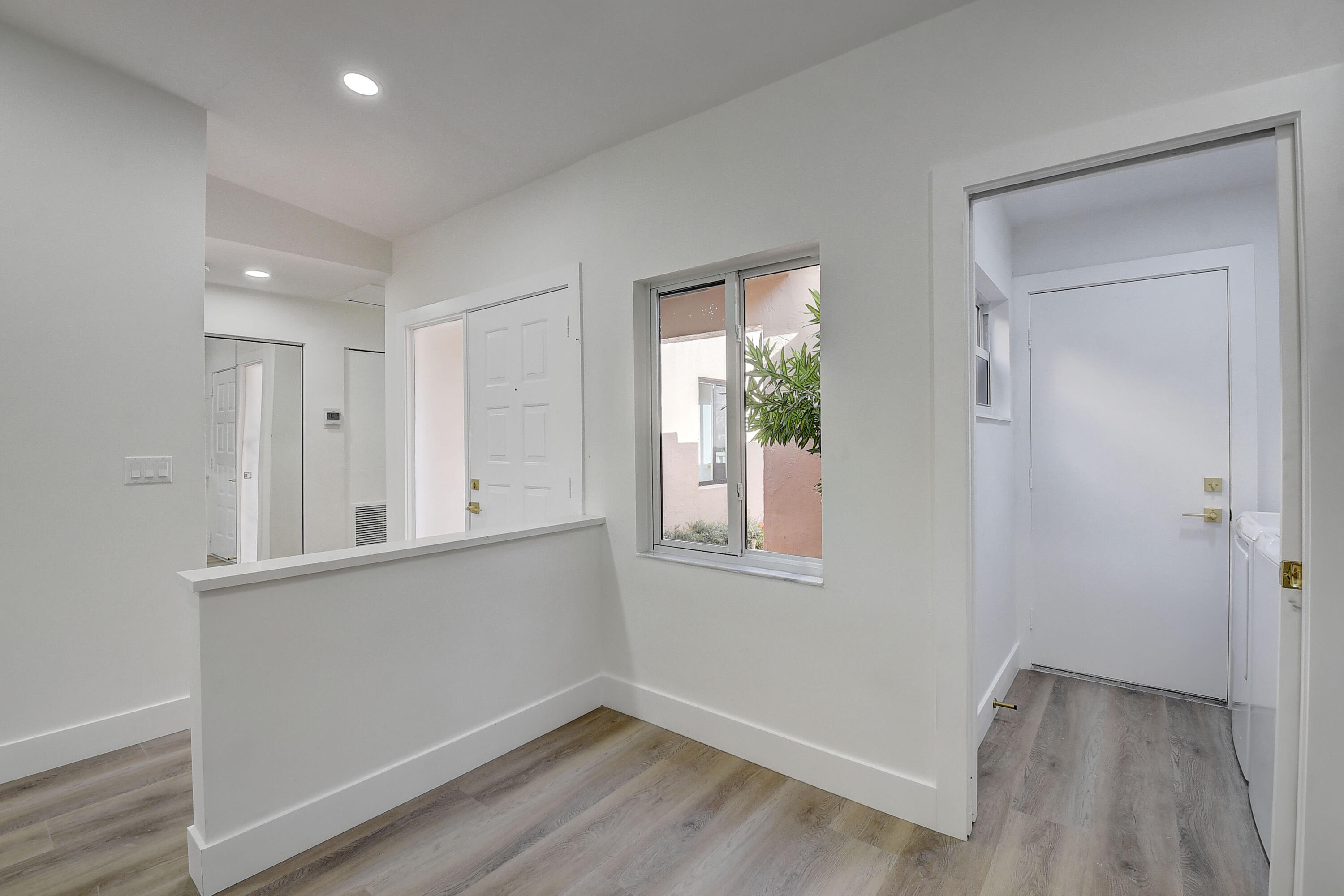 8204 Summerbreeze Lane Boca Raton, FL 33496 - Photo 16 of 47 a view of an empty room with wooden floor and a window