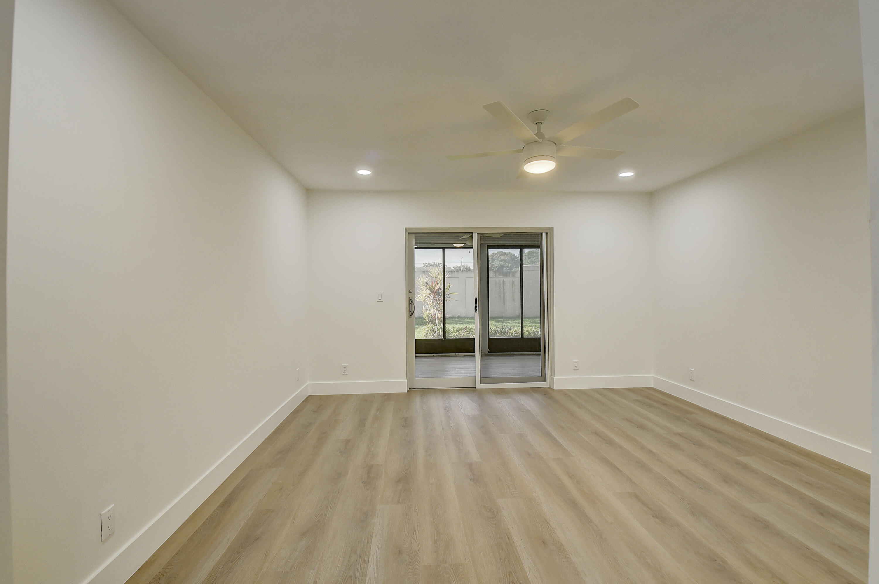 8204 Summerbreeze Lane Boca Raton, FL 33496 - Photo 18 of 47 a view of an empty room with wooden floor
