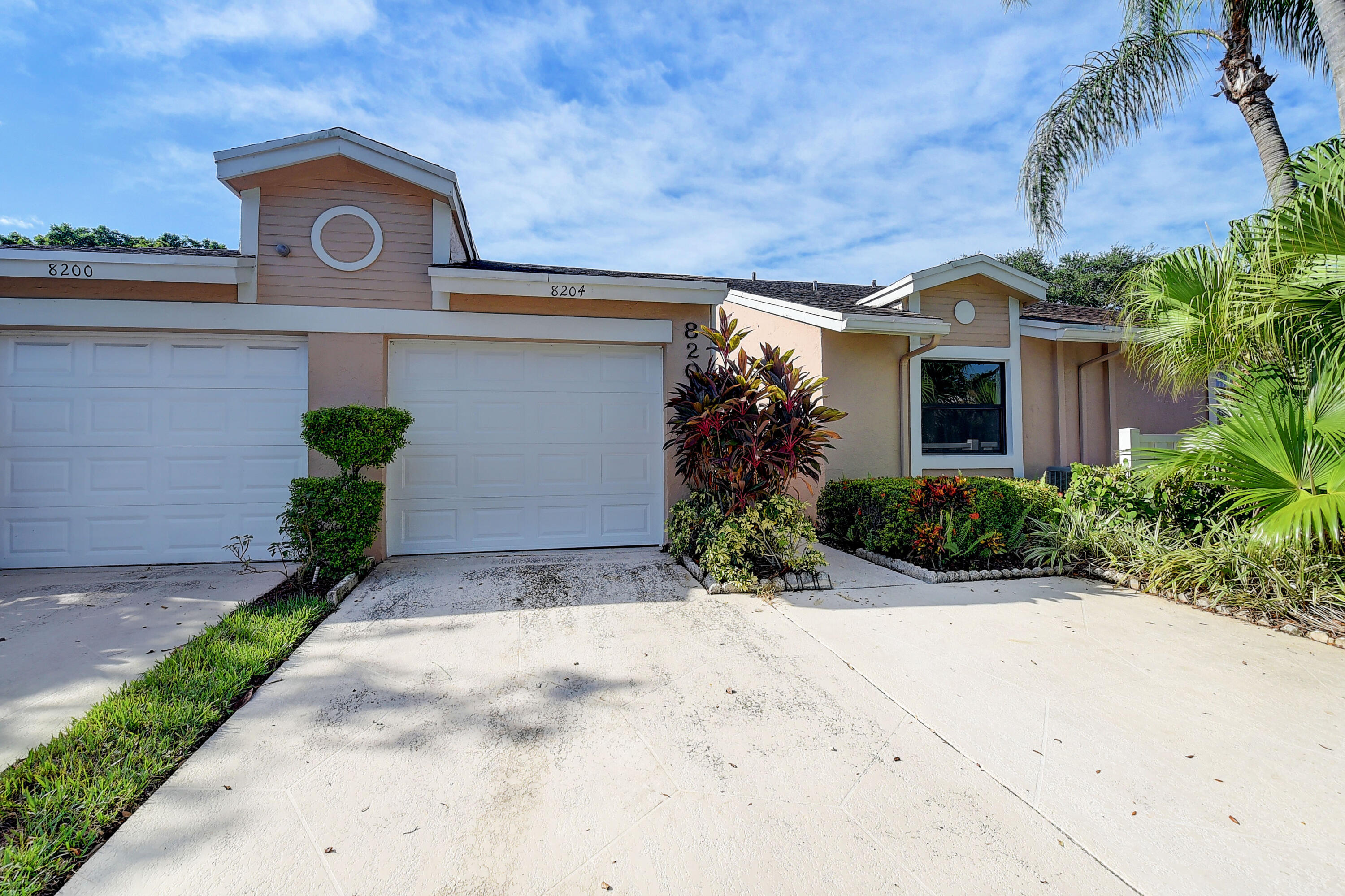 8204 Summerbreeze Lane Boca Raton, FL 33496 - Photo 2 of 47 a front view of a house with garden