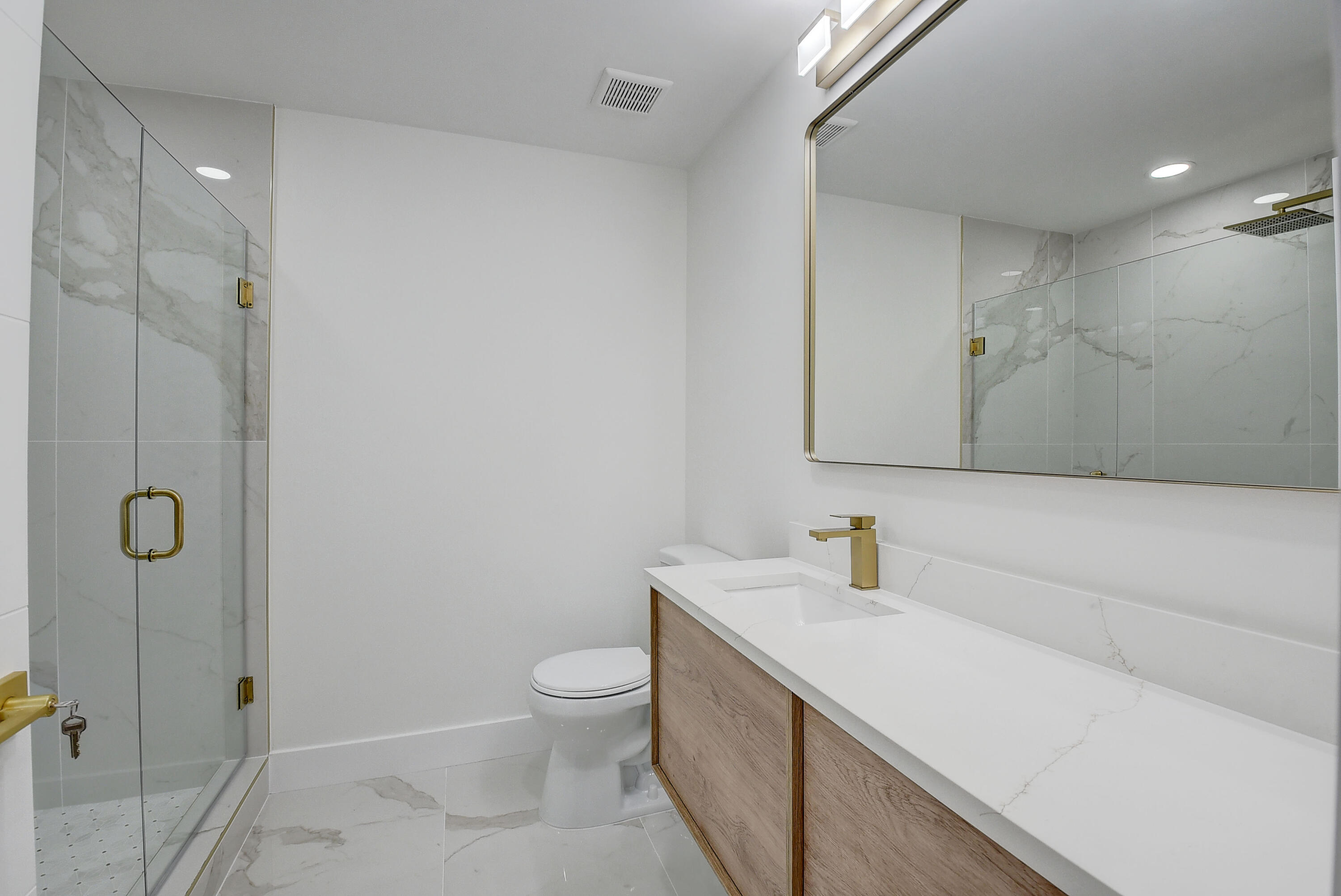 8204 Summerbreeze Lane Boca Raton, FL 33496 - Photo 25 of 47 a bathroom with a sink a toilet and shower