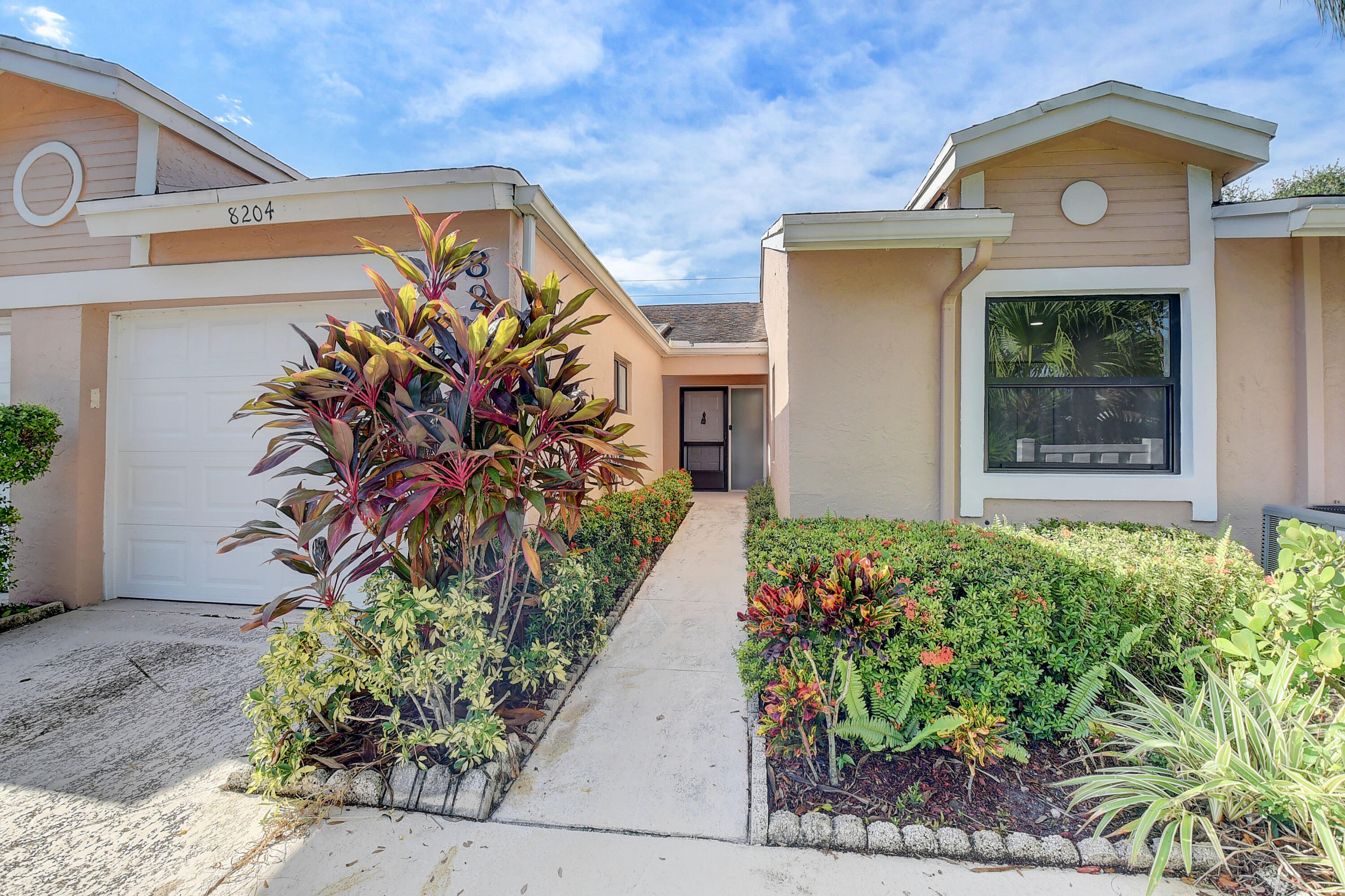 8204 Summerbreeze Lane Boca Raton, FL 33496 - Photo 3 of 47 a front view of a house with garden