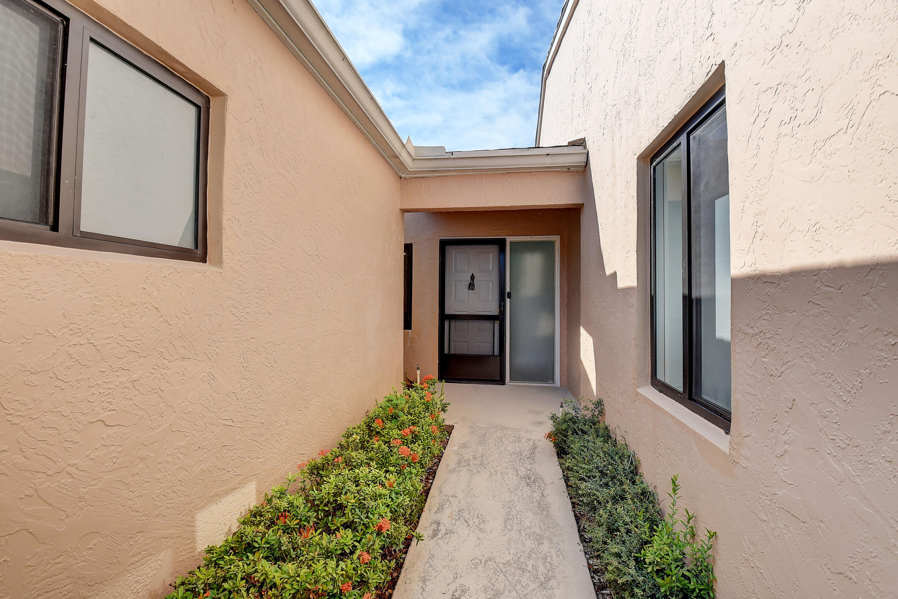 8204 Summerbreeze Lane Boca Raton, FL 33496 - Photo 4 of 47 a front view of a house with a yard