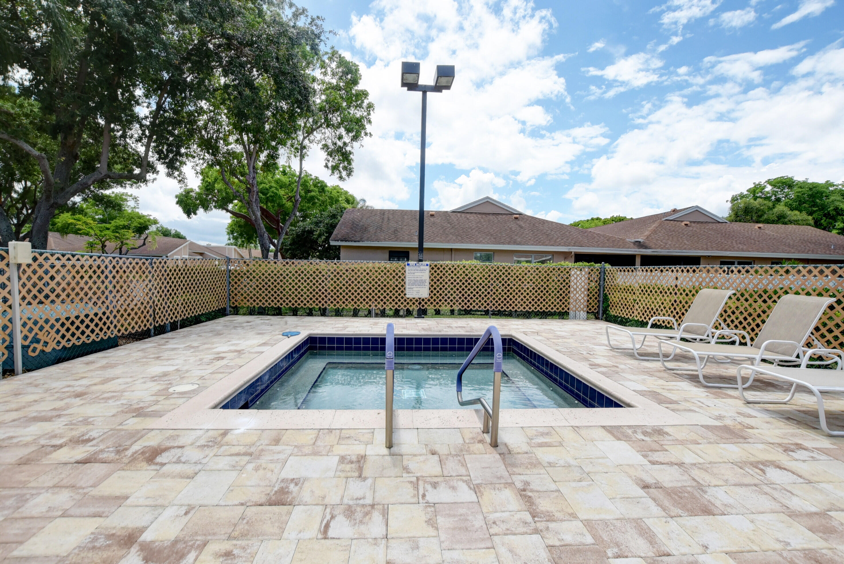 8204 Summerbreeze Lane Boca Raton, FL 33496 - Photo 46 of 47 a backyard of a house with swimming pool and outdoor seating