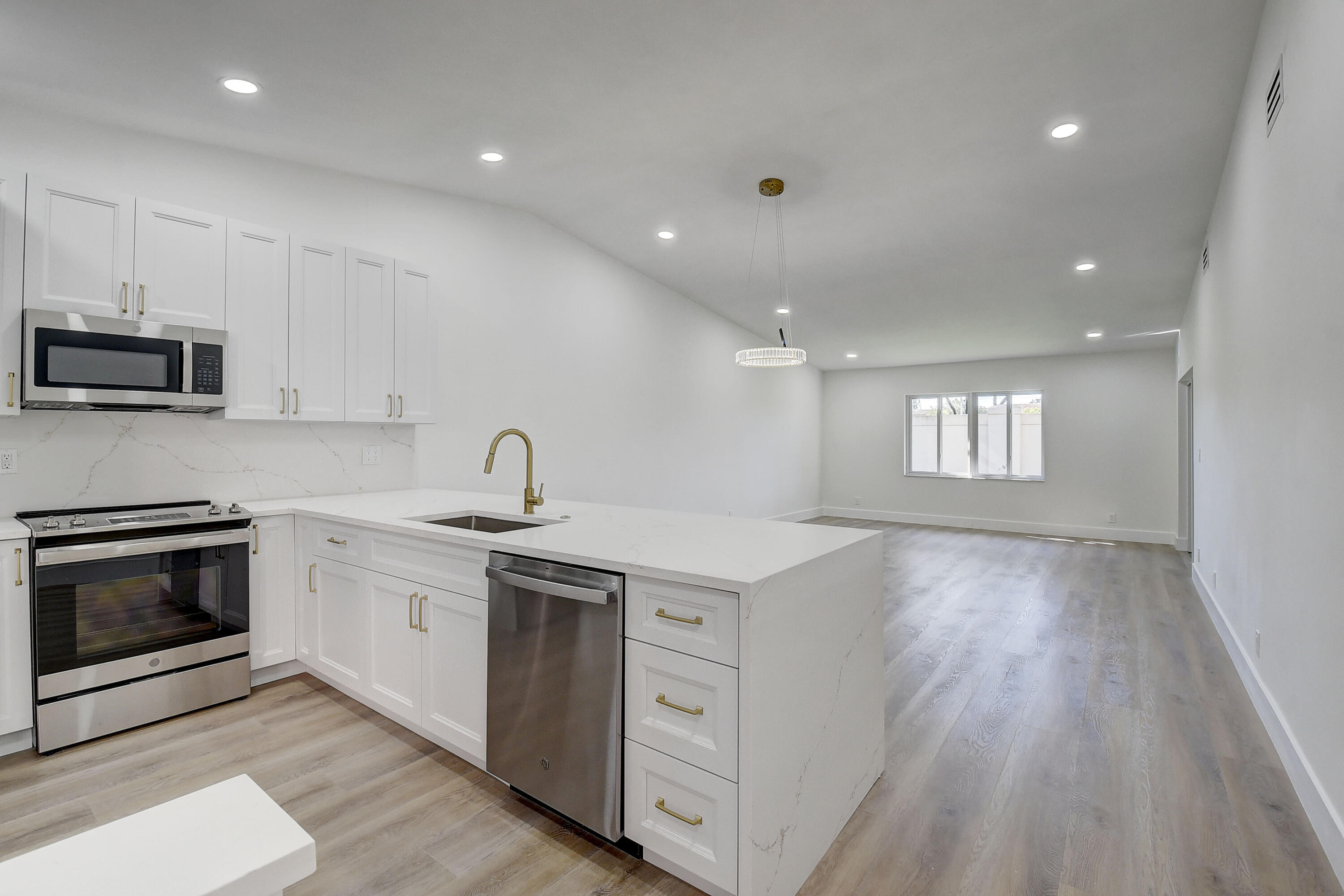 8204 Summerbreeze Lane Boca Raton, FL 33496 - Photo 6 of 47 a kitchen that has a sink and a stove top oven