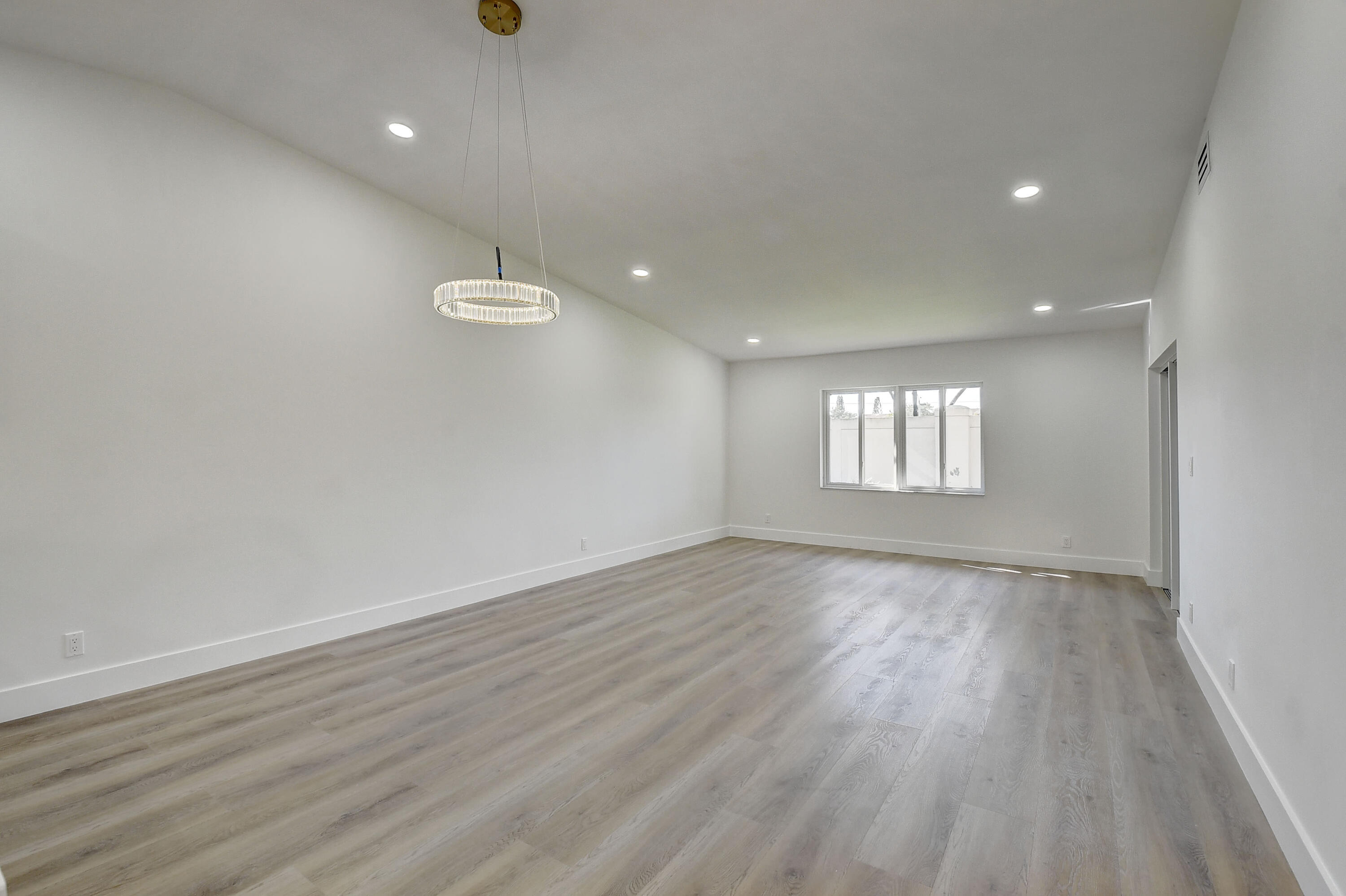8204 Summerbreeze Lane Boca Raton, FL 33496 - Photo 7 of 47 wooden floor in an empty room with a window