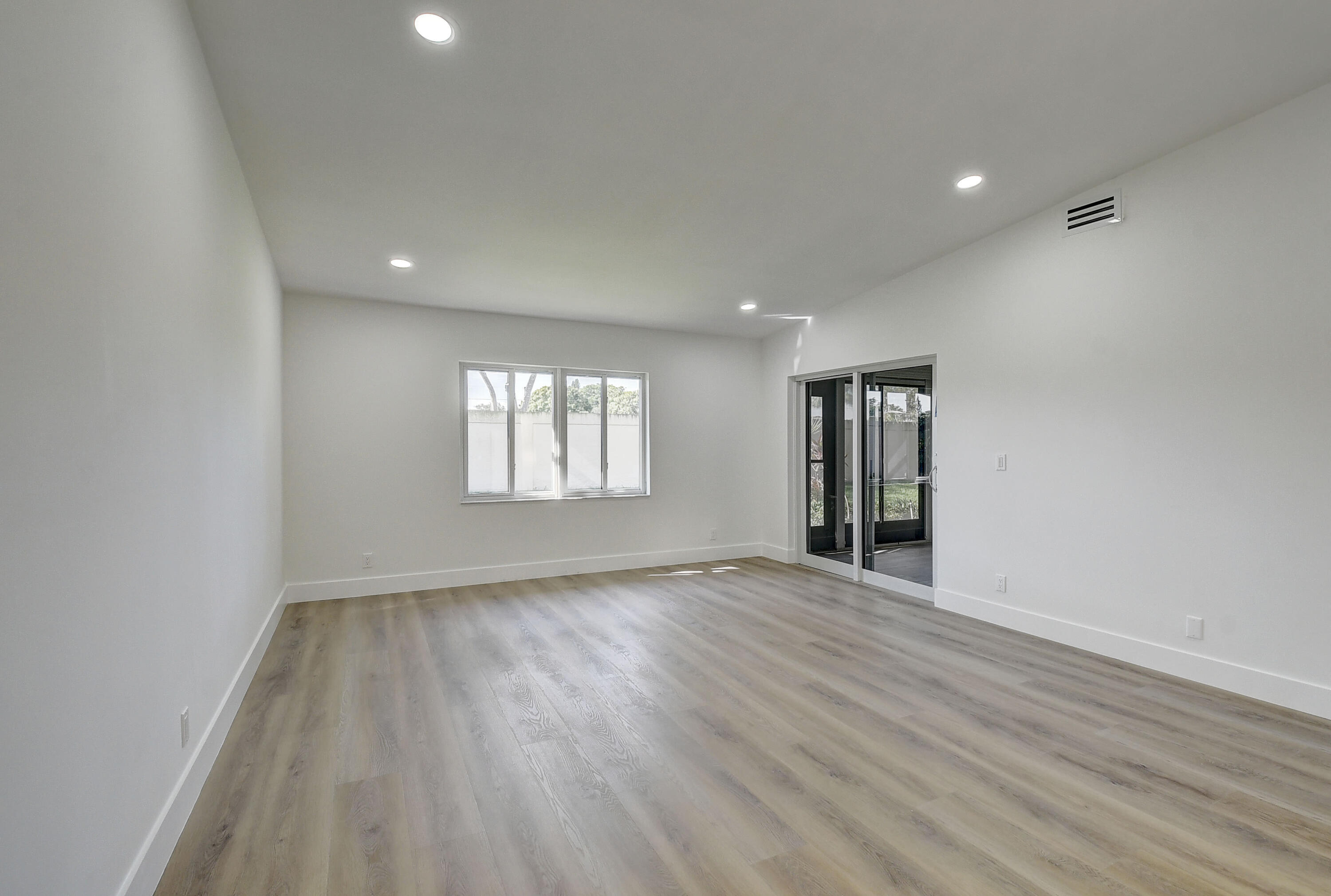 8204 Summerbreeze Lane Boca Raton, FL 33496 - Photo 8 of 47 an empty room with wooden floor and windows