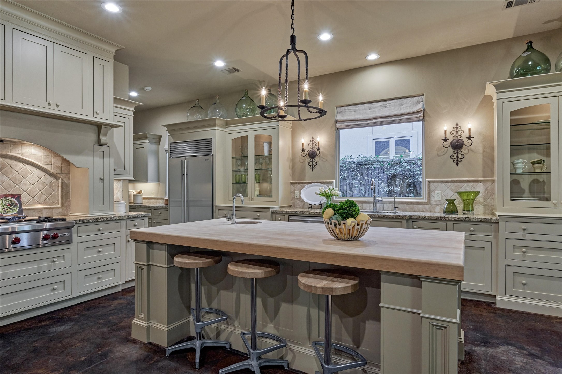 7 Dorset Square The Woodlands, TX 77381 - Photo 2 of 50 Chef’s kitchen - features include butcher-block island, Sub-Zero refrigerator, Wolf gas range with griddle, vegetable sink, glass display cabinets & pull-out spice racks.