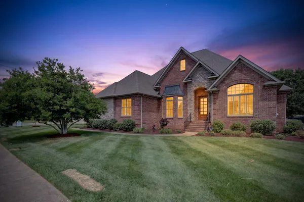 a front view of a house with a yard
