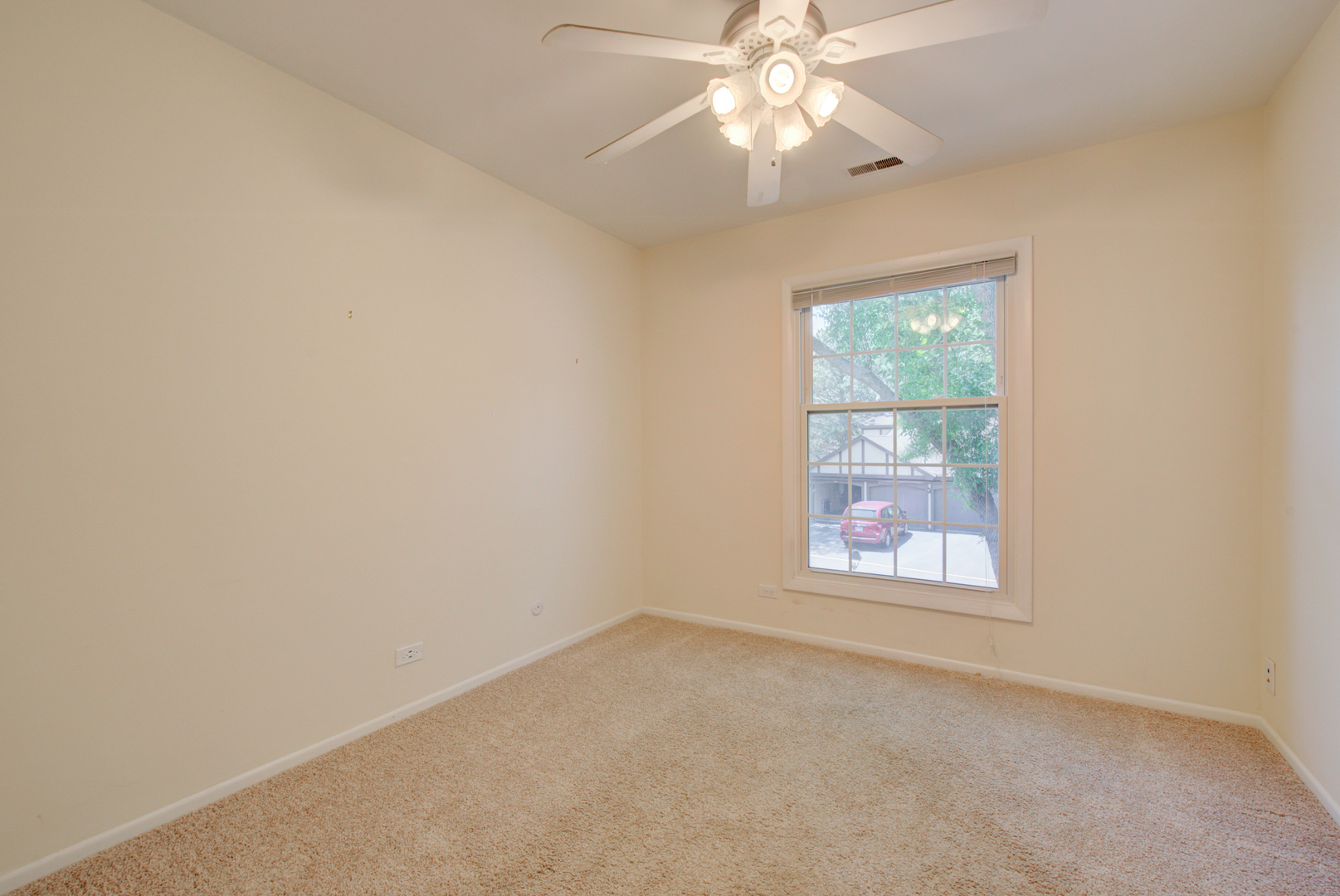 2710 Northampton Drive, Unit C2 Rolling Meadows, IL 60008 - Photo 14 of 19 an empty room with a window and a fan