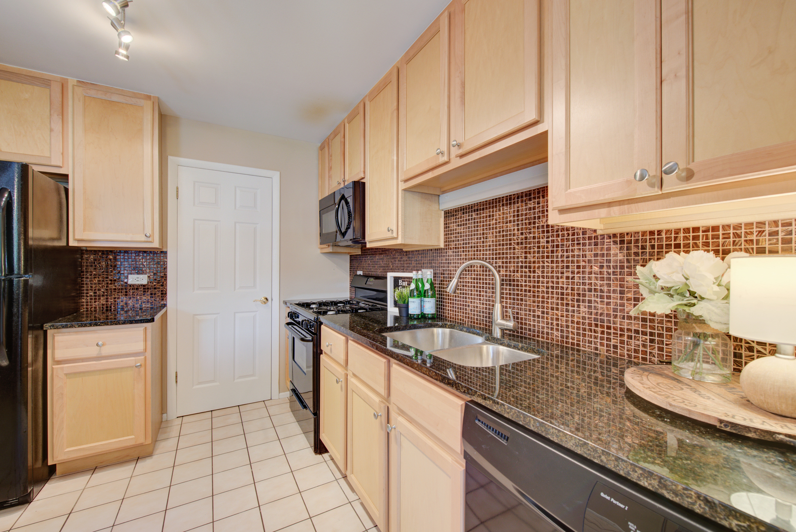 2710 Northampton Drive, Unit C2 Rolling Meadows, IL 60008 - Photo 7 of 19 a kitchen with stainless steel appliances granite countertop a sink stove refrigerator and cabinets