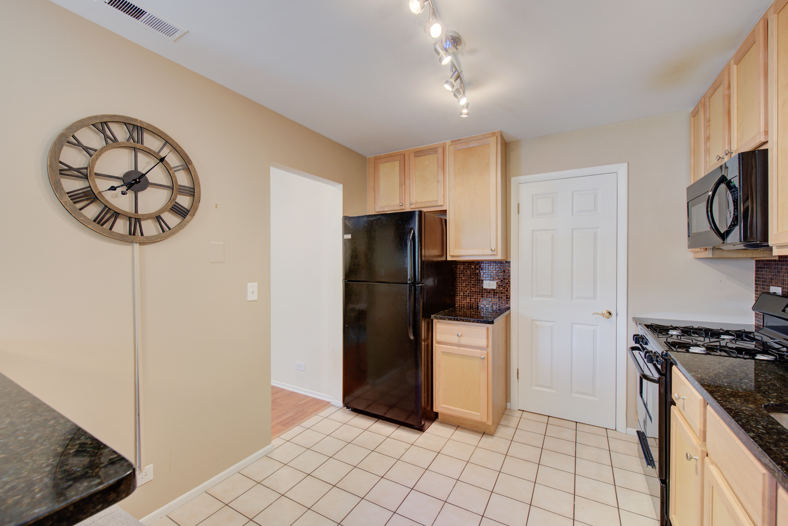 2710 Northampton Drive, Unit C2 Rolling Meadows, IL 60008 - Photo 8 of 19 a kitchen with a refrigerator and a stove top oven